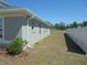 Side view of home with white vinyl fence and well maintained yard at 4373 Ne 31St St, Ocala, FL 34470