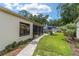 Expansive backyard with a paved walkway that leads to an outdoor seating beneath a large blue umbrella at 4404 Ne 4Th St, Ocala, FL 34470