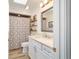 Bright bathroom with updated vanity, faucet, and shower with patterned curtain at 4404 Ne 4Th St, Ocala, FL 34470