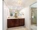 Spacious primary bathroom with double vanity, a large mirror, and glass shower at 4404 Ne 4Th St, Ocala, FL 34470