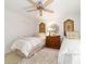 Charming bedroom with two twin beds, ceiling fan and elegant decor at 4404 Ne 4Th St, Ocala, FL 34470