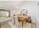 Bright dining room features a crystal chandelier, large windows, and cottage-style decor at 4404 Ne 4Th St, Ocala, FL 34470