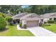 Single car garage with manicured lawn and walkway at 4404 Ne 4Th St, Ocala, FL 34470