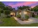Charming single-story home at dusk featuring manicured landscaping, a cozy entrance, and an attached garage at 4404 Ne 4Th St, Ocala, FL 34470