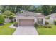 Single car garage with manicured lawn and walkway at 4404 Ne 4Th St, Ocala, FL 34470