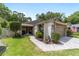 Charming single-story home featuring a manicured lawn, neutral color palette, and a brick-paved driveway at 4404 Ne 4Th St, Ocala, FL 34470