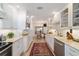 Galley kitchen features white cabinets, stainless appliances, and ample counter space at 4404 Ne 4Th St, Ocala, FL 34470