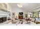 Bright living room featuring a fireplace, vaulted ceilings, and a large opening to the outside patio at 4404 Ne 4Th St, Ocala, FL 34470