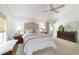 Bright main bedroom features vaulted ceilings, and a tufted headboard with access to backyard at 4404 Ne 4Th St, Ocala, FL 34470