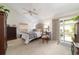 Vaulted ceiling main bedroom with a tufted headboard and sliding glass doors to the backyard at 4404 Ne 4Th St, Ocala, FL 34470