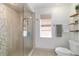 Updated bathroom with a glass enclosed shower, tile walls, and a built-in niche at 4404 Ne 4Th St, Ocala, FL 34470