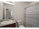 Bright bathroom features granite countertop, and a shower with a striped curtain at 4721 Se 36Th St, Ocala, FL 34480