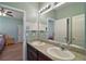 Dual sink vanity in the bathroom with granite counter top and large mirror at 4721 Se 36Th St, Ocala, FL 34480
