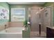 Bright bathroom featuring a bathtub, glass shower, a window and tile floors for relaxation and comfort at 4721 Se 36Th St, Ocala, FL 34480