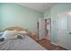 A cute bedroom with light green walls and luxury vinyl plank flooring at 4721 Se 36Th St, Ocala, FL 34480