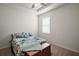 Bright bedroom featuring a window and a floral-patterned comforter at 4721 Se 36Th St, Ocala, FL 34480