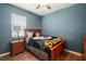 A cozy blue bedroom with hardwood floors and a plush blanket at 4721 Se 36Th St, Ocala, FL 34480