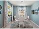 Sunlit dining room with a large round table and blue walls for an inviting and comfortable dining experience at 4721 Se 36Th St, Ocala, FL 34480