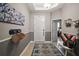 View of the home's entryway featuring tile flooring, neutral walls, decor, and a glimpse into the main bedroom at 4721 Se 36Th St, Ocala, FL 34480