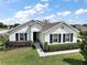 Inviting single-story home featuring a well-maintained lawn and classic blue shutters at 4721 Se 36Th St, Ocala, FL 34480