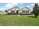 Charming single-story home with blue shutters and manicured landscaping at 4721 Se 36Th St, Ocala, FL 34480