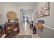 Long hallway boasts neutral walls with decor and views of the open-concept kitchen and dining space at 4721 Se 36Th St, Ocala, FL 34480