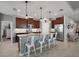 A full kitchen view of stainless steel appliances, an island with seating, granite countertops, and tile floors at 4721 Se 36Th St, Ocala, FL 34480