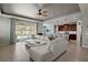 View of the living room showcasing an open layout with access to the backyard, dining room, and kitchen at 4721 Se 36Th St, Ocala, FL 34480