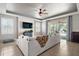 Living room featuring a ceiling fan, backyard view and a shiplap wall creating a welcoming atmosphere at 4721 Se 36Th St, Ocala, FL 34480