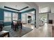 Open-concept living room and dining area with tile floors, plenty of natural light, and a modern color scheme at 4721 Se 36Th St, Ocala, FL 34480