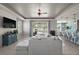 Open-concept living room featuring neutral colors, shiplap accent wall and tile floors leading into the kitchen and dining areas at 4721 Se 36Th St, Ocala, FL 34480