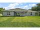 The home's back exterior with a covered patio perfect for outdoor living and entertaining at 4743 Se 34Th St, Ocala, FL 34480