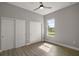 Bedroom with ceiling fan, wood floors, window, and closet featuring panel doors at 4743 Se 34Th St, Ocala, FL 34480
