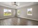 Bright main bedroom with ceiling fan, tray ceiling, and three windows offering lots of natural light at 4743 Se 34Th St, Ocala, FL 34480