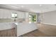A modern kitchen boasts white cabinets, an island with countertop, and seamless access to the backyard at 4743 Se 34Th St, Ocala, FL 34480