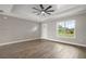 Cozy living room featuring a large window, stylish ceiling fan, and wood-look flooring at 4743 Se 34Th St, Ocala, FL 34480