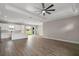 Bright, open-concept living space flows into kitchen with luxury vinyl plank flooring and coffered ceiling at 4743 Se 34Th St, Ocala, FL 34480