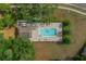 Aerial view of a community pool with lounge chairs and a nearby building at 5128 Grassy Knoll Dr, Tavares, FL 32778