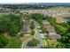 Community aerial featuring lined streets, lush foliage, community pool, and solar panels on the roof at 5128 Grassy Knoll Dr, Tavares, FL 32778