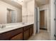 Bathroom featuring a double sink vanity, large mirror, and neutral color palette at 5128 Grassy Knoll Dr, Tavares, FL 32778