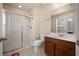 Bathroom featuring a step-in shower, vanity with wood cabinetry, and a commode at 5128 Grassy Knoll Dr, Tavares, FL 32778