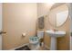 Practical half bathroom with a pedestal sink and neutral finishes at 5128 Grassy Knoll Dr, Tavares, FL 32778