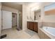 Bright bathroom features a soaking tub, walk-in shower, and a vanity with ample counter space at 5128 Grassy Knoll Dr, Tavares, FL 32778