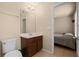Bathroom featuring neutral walls, a dark wood vanity with a single sink, commode, and mirror at 5128 Grassy Knoll Dr, Tavares, FL 32778