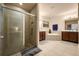 Modern bathroom with glass-enclosed shower, soaking tub, double vanity, tile flooring, and recessed lighting at 5128 Grassy Knoll Dr, Tavares, FL 32778