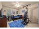 Bedroom with large bed, desk, posters and an exercise machine near a window at 5128 Grassy Knoll Dr, Tavares, FL 32778