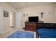 Neutral bedroom with door to hall, TV, and furnishings at 5128 Grassy Knoll Dr, Tavares, FL 32778
