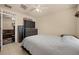 Bedroom features neutral walls, ceiling fan, and view to the living room through an open door at 5128 Grassy Knoll Dr, Tavares, FL 32778
