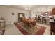 Open dining area with a classic wooden table, adjacent to the modern kitchen at 5128 Grassy Knoll Dr, Tavares, FL 32778