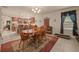 Cozy dining room featuring a wooden table and chandelier, seamlessly connected to the kitchen at 5128 Grassy Knoll Dr, Tavares, FL 32778